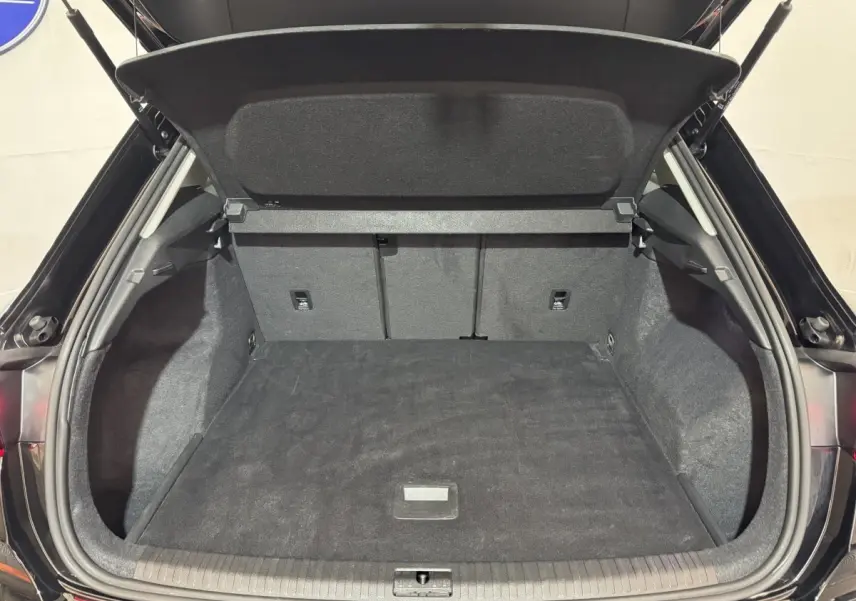 Coffre ouvert vu de l'arrière d'un Audi Q3 noir 2022, montrant un espace de chargement propre et spacieux.