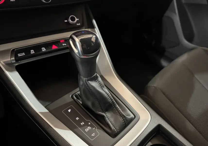 Le levier de vitesse automatique noir de l'Audi Q3 35 TFSI 2022 vu en gros plan côté passager.