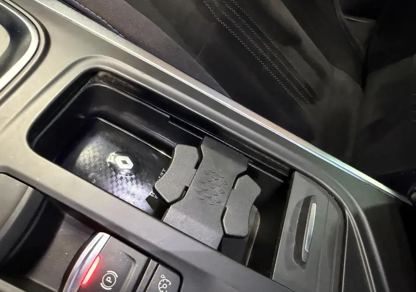 Gros plan sur la console centrale de la Renault Mégane Break GT gris, avec porte-gobelets et commandes électroniques.