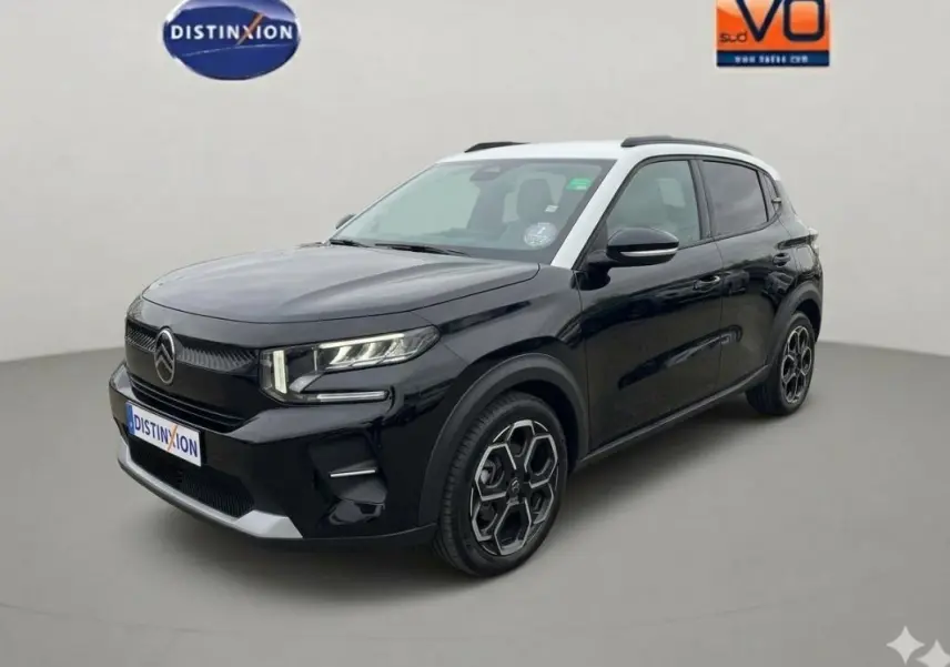 Citroën C3 noir vue 3/4 avant droit, avec toit blanc, barres de toit et jantes alliage 17 pouces.