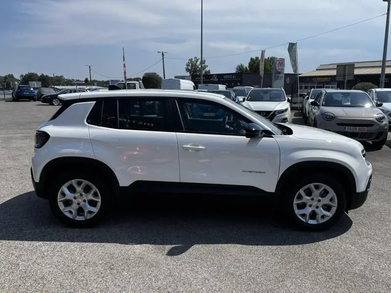 Vue de profil côté gauche du Jeep Avenger électrique blanc 2025, avec jantes alliage et détails noirs contrastants.