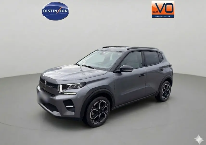 Citroën C3 Turbo 100 ch gris vue 3/4 avant droit, avec barres de toit et jantes alliage 17 pouces.