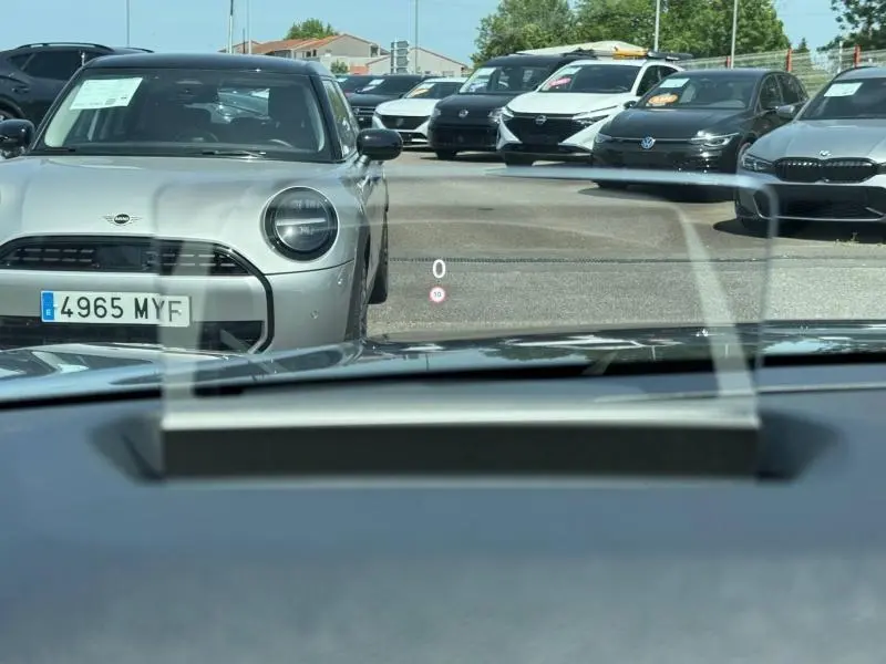 Vue avant d'une Citroën C4 gris Mercury avec toit noir, visible à travers le pare-brise depuis l'intérieur du véhicule.