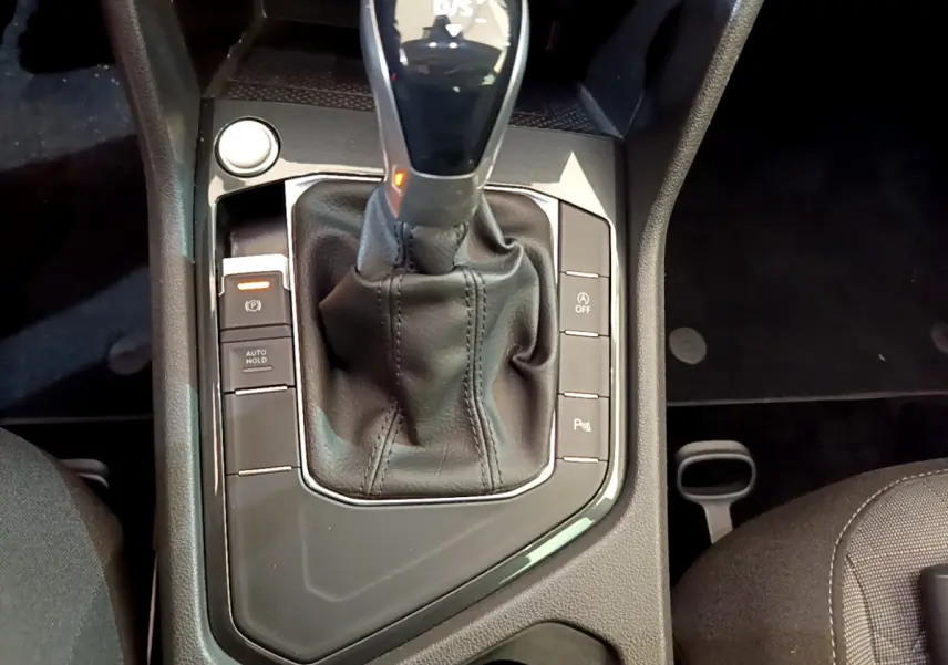 Vue rapprochée de la console centrale du Volkswagen Tiguan 2021, levier de vitesse DSG7 avec boutons de contrôle noirs.