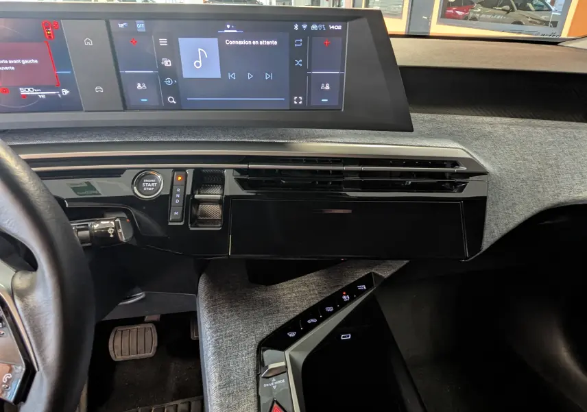 Vue intérieure du tableau de bord du Peugeot 3008 Hybrid blanc, avec écran tactile large et commandes modernes sur console centrale.