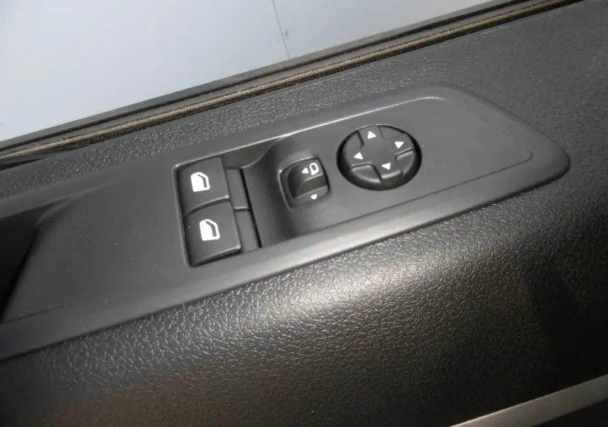 Gros plan sur les commandes de réglage des rétroviseurs et des vitres côté conducteur du Peugeot Expert Blanc 2023.
