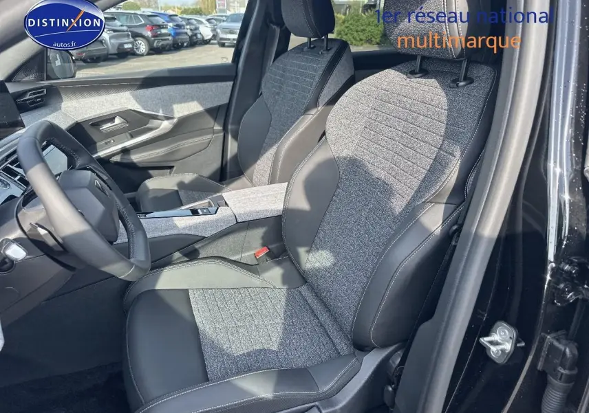Vue intérieure côté conducteur du Peugeot 3008 1.2 hybrid 145 allure e-dcs6 noir, sièges tissu et cuir bicolore.