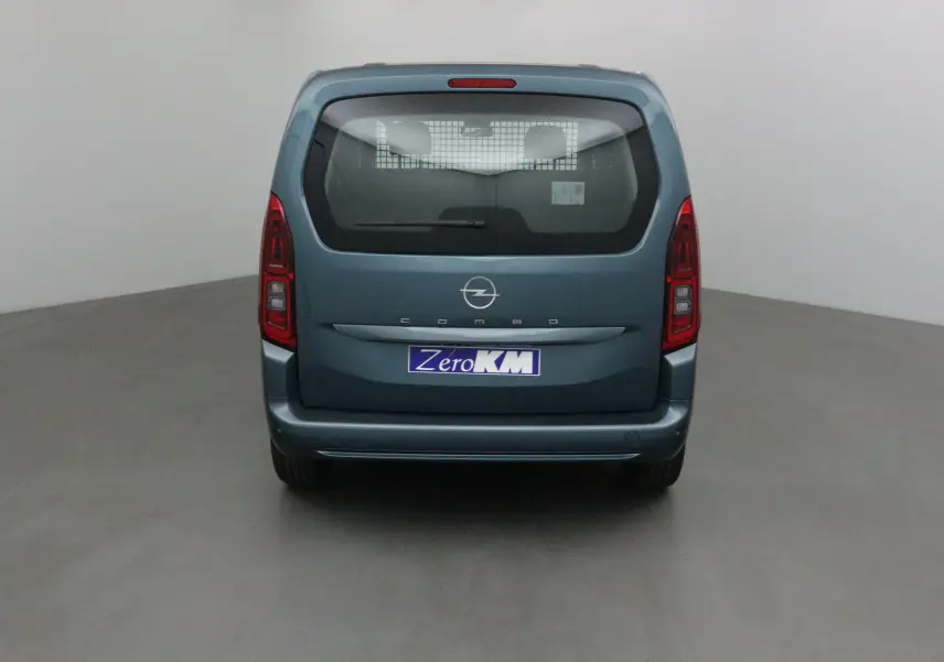 Vue arrière d'un Opel Combo Life bleu Kiama avec vitre arrière et grille de séparation visible.