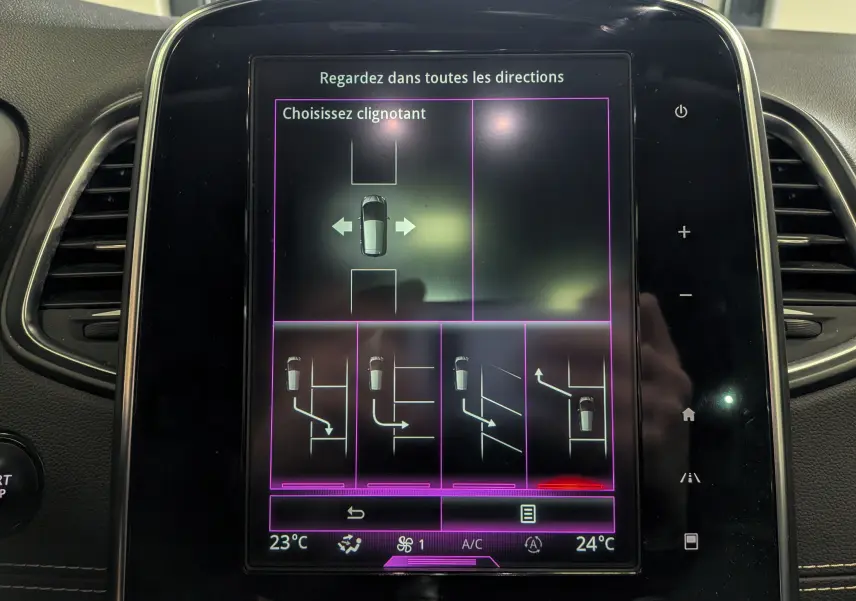 Écran tactile central du Renault Scénic IV noir étoilé de 2018 montrant les options d’aide au stationnement et de clignotants.
