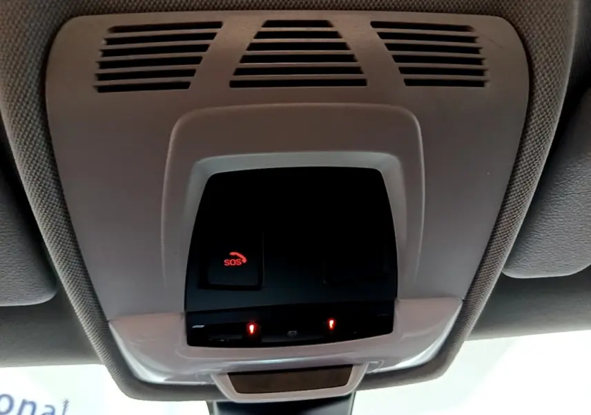 Vue en contre-plongée du plafonnier gris avec bouton SOS rouge allumé dans une BMW X2 gris foncé 2021.