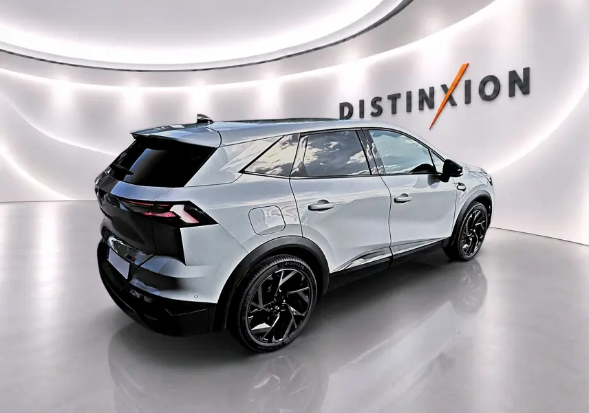 Vue 3/4 arrière droite du Renault Symbioz gris rafale avec jantes noires et toit noir dans un showroom lumineux.