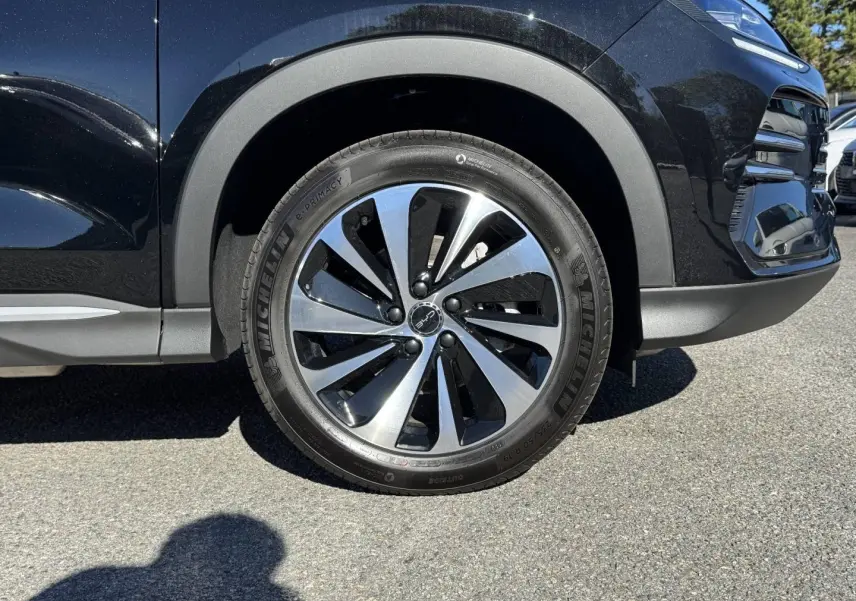 Gros plan sur la roue avant gauche d’un BYD SEAL U noir métallisé avec jante alu bicolore et pneus Michelin.