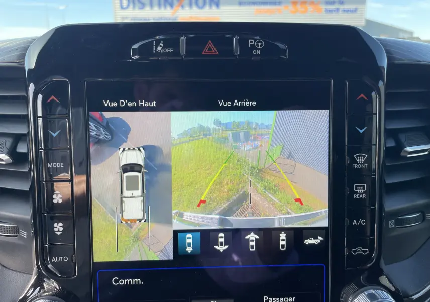 Écran central du Dodge RAM 1500 blanc nacré montrant la caméra 360° avec vue aérienne et arrière du véhicule.