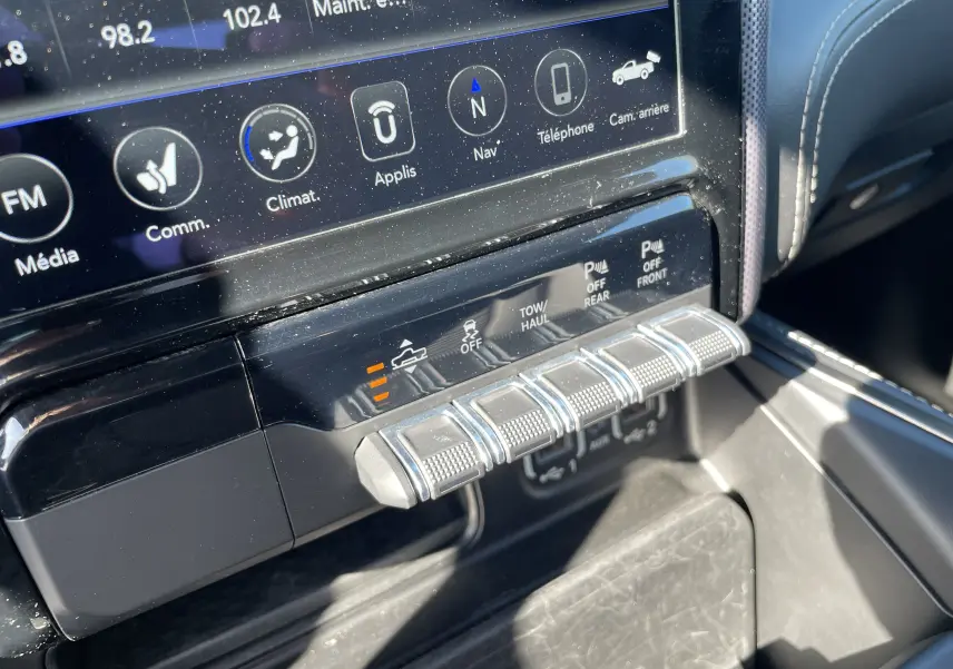 Gros plan sur les commandes et l'écran tactile du tableau de bord du Dodge RAM 1500 blanc nacré, version Limited 2020.