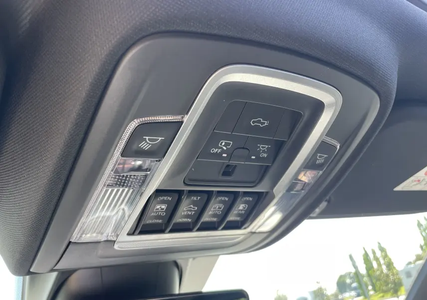Gros plan sur la console de plafonnier du Dodge RAM 1500 2020, avec commandes d'éclairage et toit ouvrant visibles.