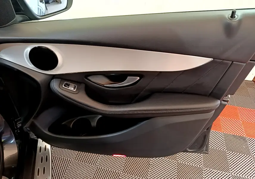 Vue rapprochée de la porte côté gauche du Mercedes GLC 300 E AMG Line 2021 en gris foncé avec insert aluminium.