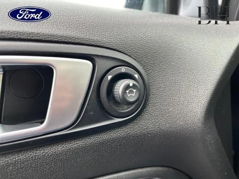 Gros plan sur le bouton de réglage des rétroviseurs côté conducteur du Ford EcoSport 2017 finition Titanium couleur Smoke.