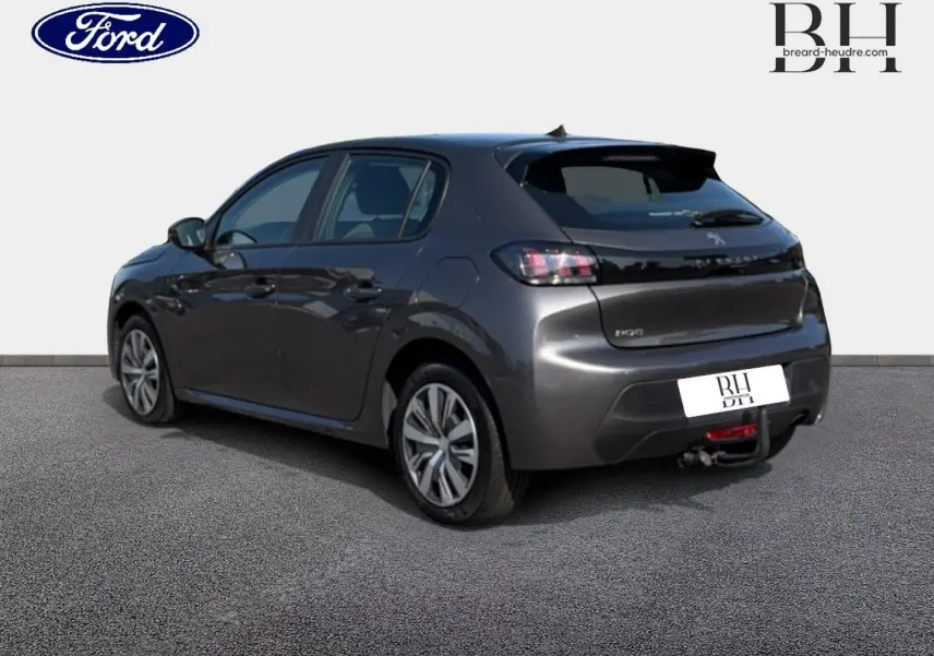 Peugeot 208 gris Platinium vue 3/4 arrière droit avec attelage visible sur fond neutre.
