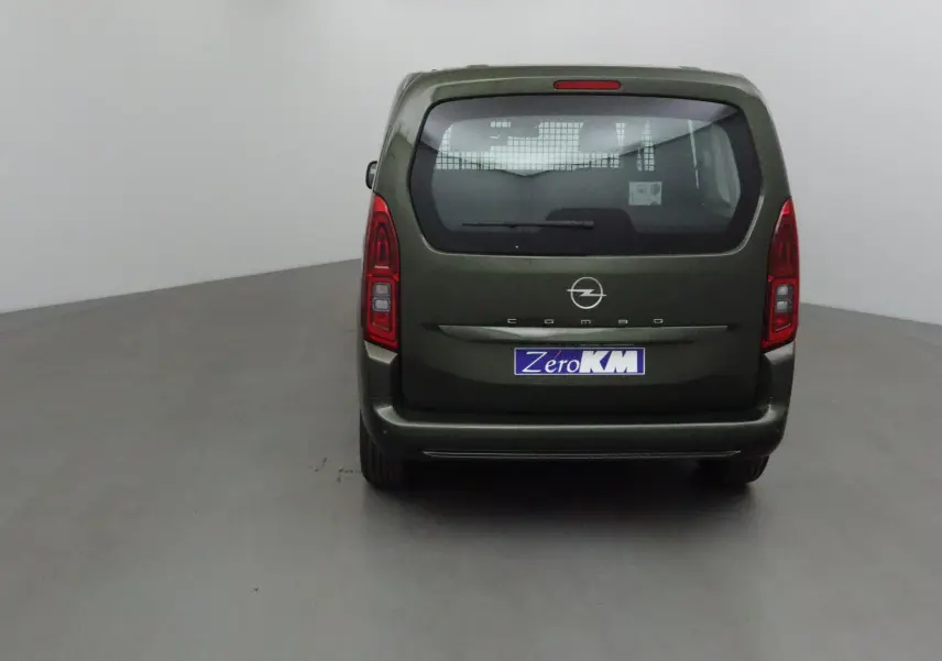 Vue arrière d'un Opel Combo Life vert Sirkka avec logo et plaque Zéro KM visible dans un studio neutre.