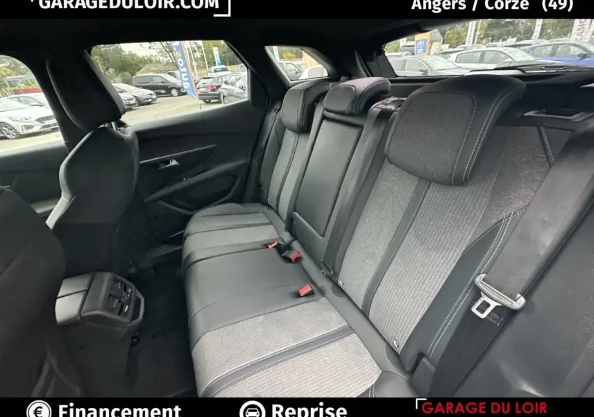 Vue intérieure des sièges arrière du Peugeot 3008 2024, tissu gris et cuir noir avec appuie-têtes intégrés.