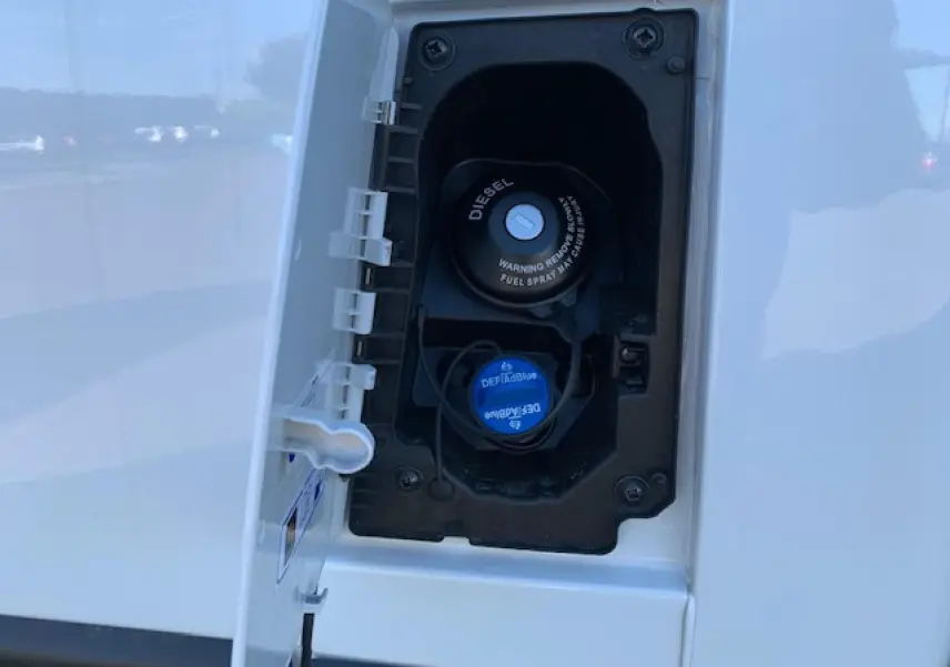 Gros plan sur la trappe à carburant diesel blanche du Fiat Ducato Fourgon 2022, avec bouchon DEF Blue bleu visible.