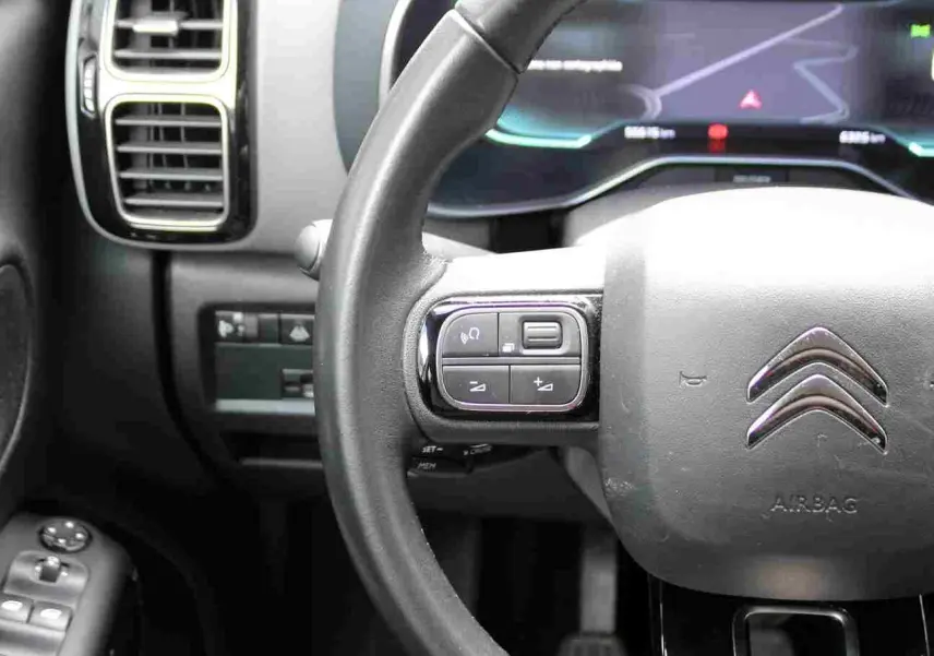 Vue rapprochée du volant et du tableau de bord numérique du Citroën C5 Aircross blanc, version Shine 2020.
