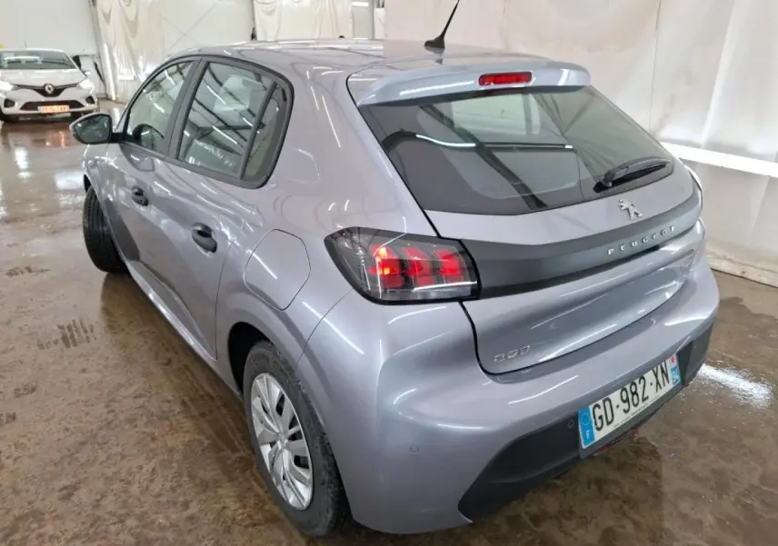 Vue 3/4 arrière droite d'une Peugeot 208 gris Artense avec feux arrière noirs et jantes tôles 15 pouces.
