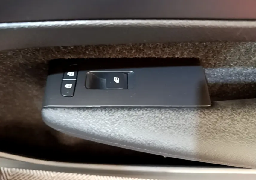 Gros plan sur les commandes de verrouillage et lève-vitre côté conducteur du Volvo XC40 T2 gris clair de 2020.