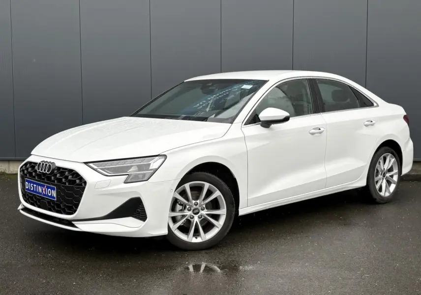 Audi A3 Berline blanc Arkona vue 3/4 avant droit, jantes alliage 17 pouces et calandre hexagonale noire.