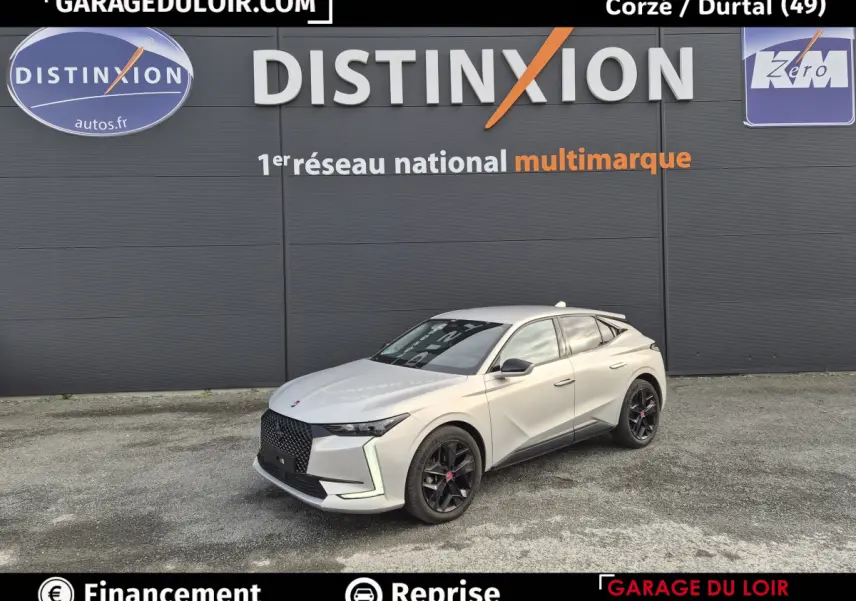 Vue 3/4 avant droite d'une DS4 beige 2024 avec calandre noire et jantes noires devant un mur gris.