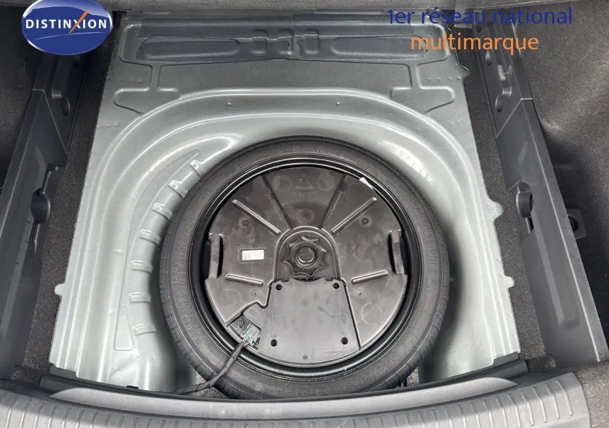 Vue plongeante sur la roue de secours dans le coffre d'une CUPRA LEON ST gris magnetic metal 2024.