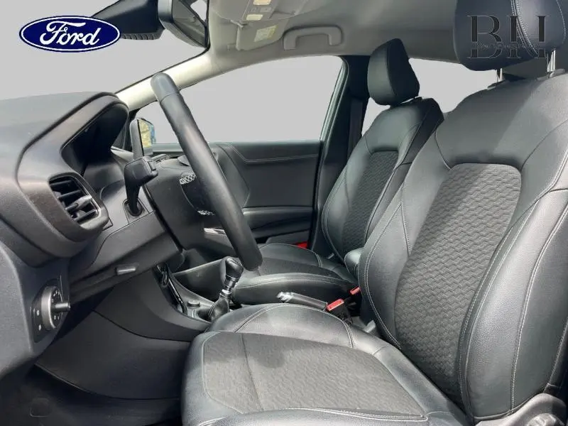 Intérieur avant du Ford Puma 2022, sièges en cuir noir avec surpiqûres, volant multifonction et levier de vitesse manuel visible.