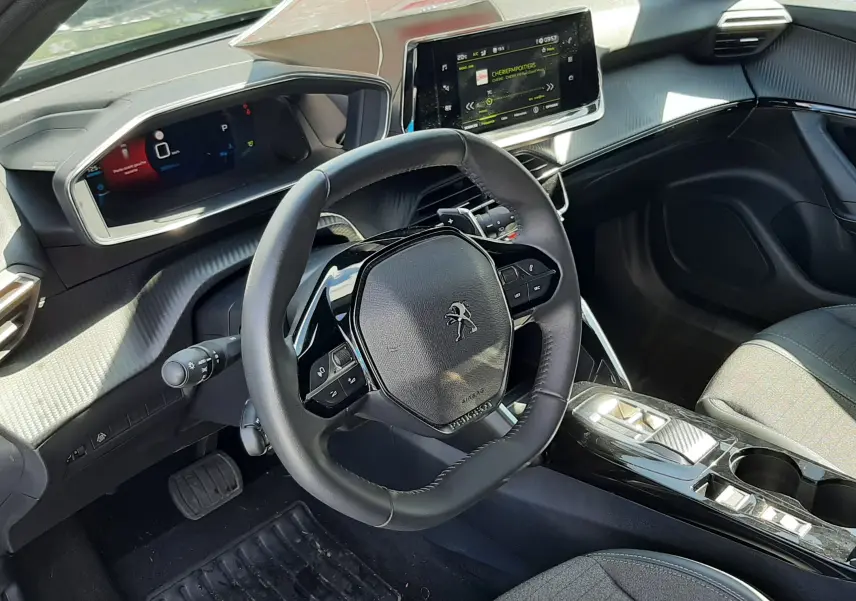 Intérieur noir du Peugeot 2008 2023 vu côté conducteur, avec tableau de bord numérique et écran tactile central.