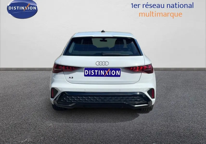 Vue arrière d'une Audi A3 Sportback blanche Ibis 2025 avec feux LED et pare-chocs noir distinctif.