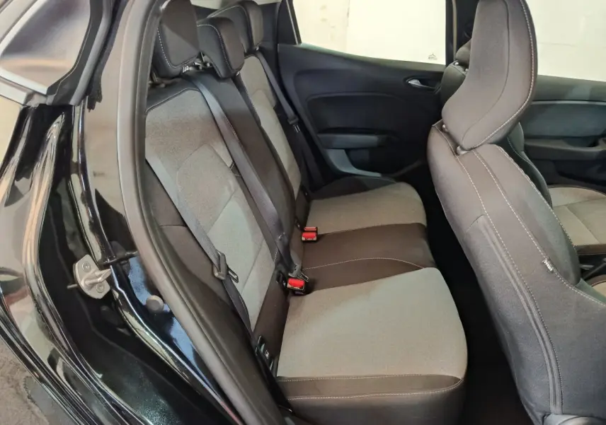 Vue intérieure côté gauche montrant la banquette arrière grise et noire de la Renault Clio Evolution Blue dCi 100 2025.