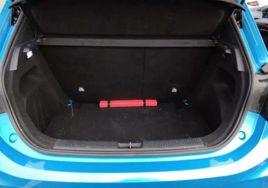 Coffre ouvert vu de l'arrière d'une MG3 1.5 Hybrid+ 195 Luxury bleu Como, avec intérieur noir et triangle de sécurité.
