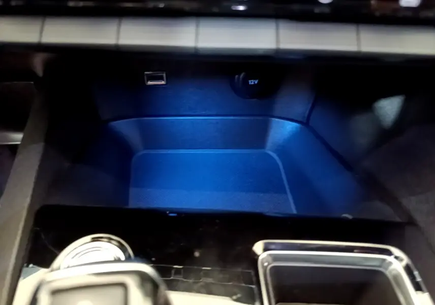 Espace de rangement avant éclairé en bleu avec prise USB et prise 12V dans un Peugeot 5008 GT 2021 Essence.