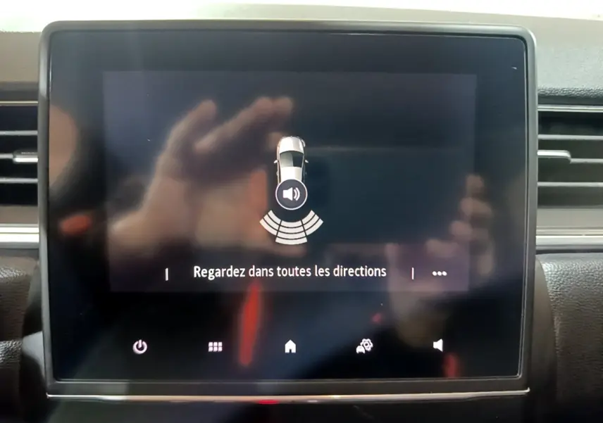 Écran tactile central du Renault Captur Intens jaune 2020 affichant l'alerte de surveillance des alentours.