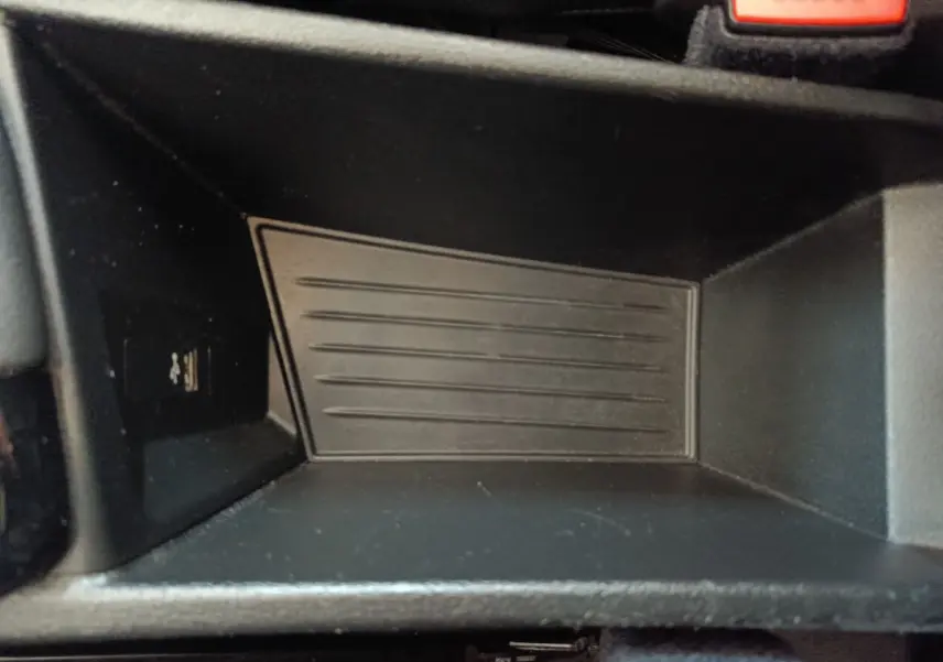 Gros plan sur le rangement intérieur noir du BMW X1 sDrive18i M Sport 2019, montrant un port USB à gauche.