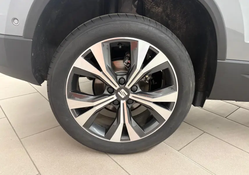 Gros plan sur la jante alliage 18'' usinée du SEAT Ateca gris graphite, mettant en valeur son design moderne.