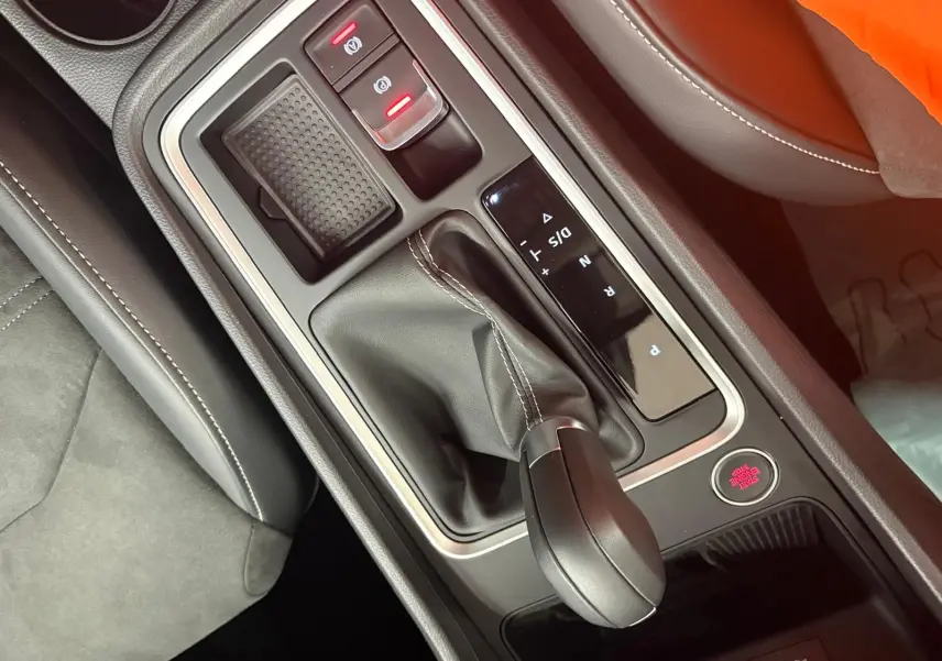 Gros plan sur la console centrale du SEAT Ateca 2.0 TDI 150 DSG7, montrant le levier de vitesse et les commandes en cuir noir.