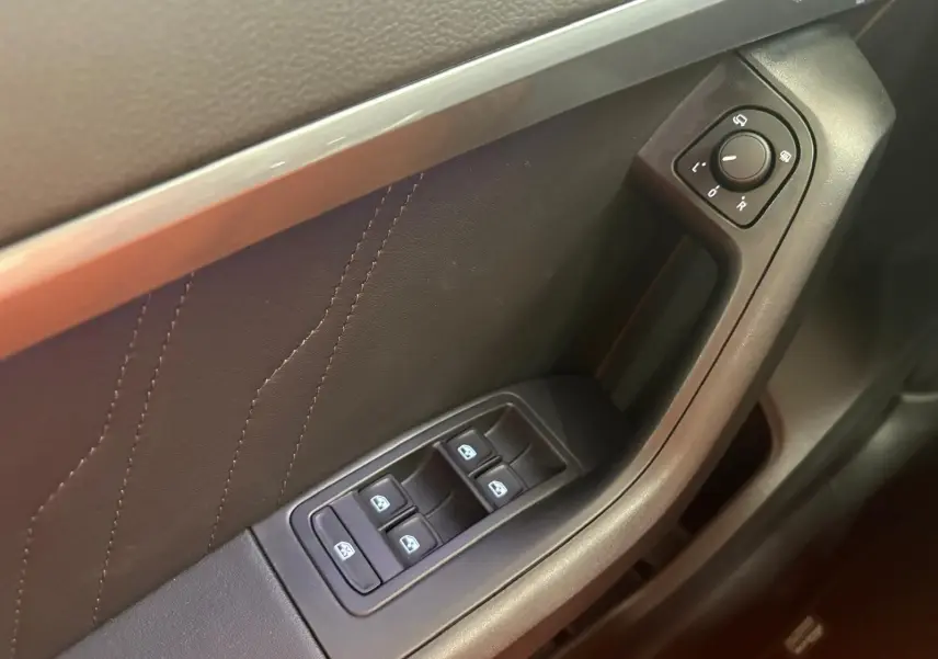 Gros plan sur la commande des vitres et réglage des rétroviseurs côté conducteur du SEAT Ateca 2.0 TDI 150 DSG7 COPA.