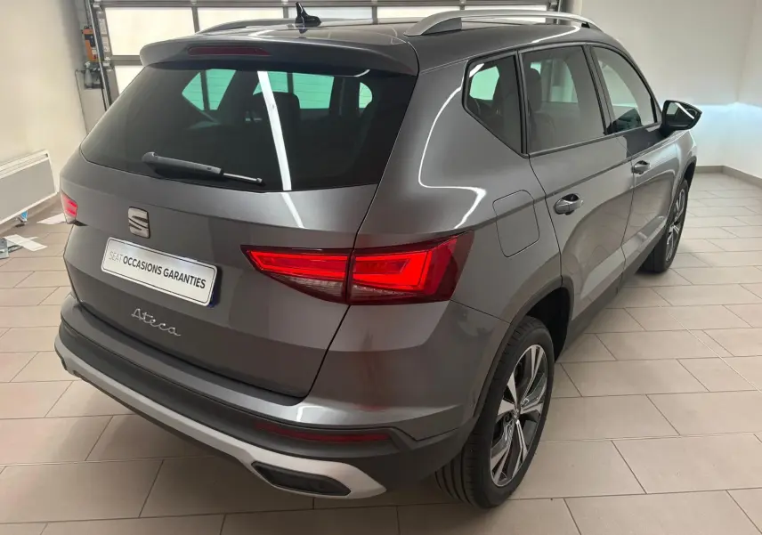 Vue 3/4 arrière droite du SEAT Ateca gris graphite 2025 avec jantes alliage 18'' et hayon électrique mains-libres.