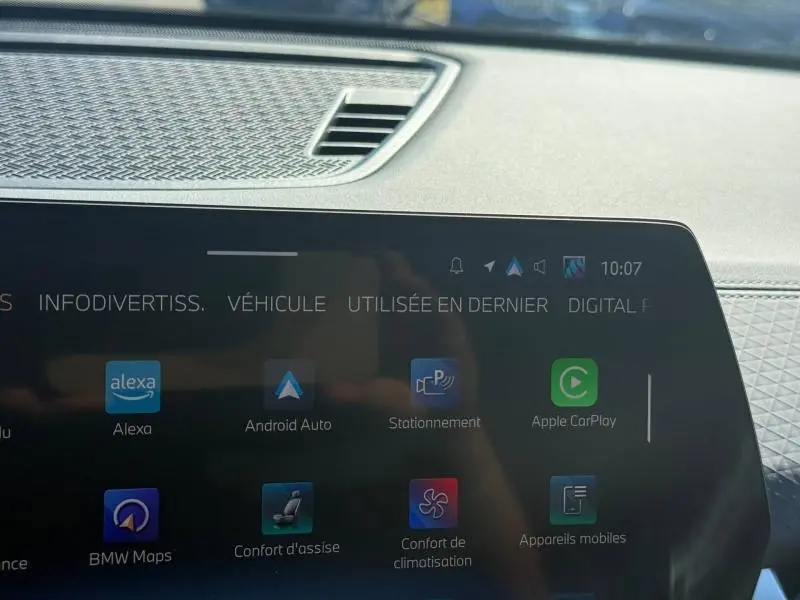 Gros plan sur l'écran tactile central du BMW X2 2025, affichant les options connectées et l'interface multimédia.