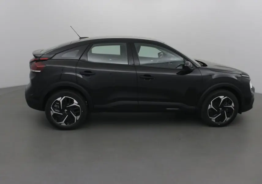 Profil côté gauche d'une Citroën C4 noire 2022 avec jantes alliage et lignes fluides modernes.