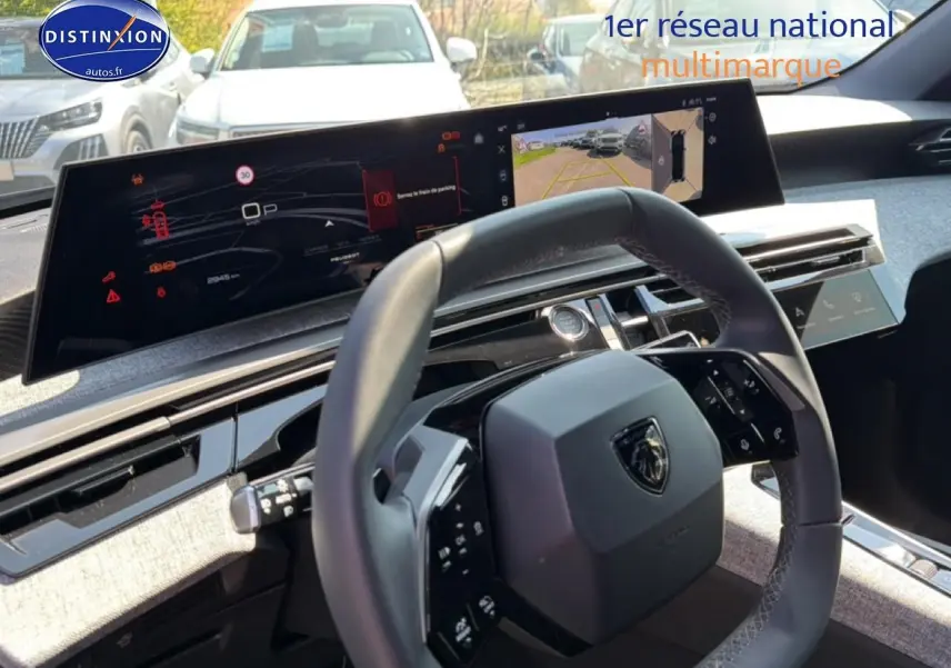 Vue intérieure du tableau de bord du Peugeot 3008 2025, volant cuir multifonction et écran tactile large affichant caméra de recul.