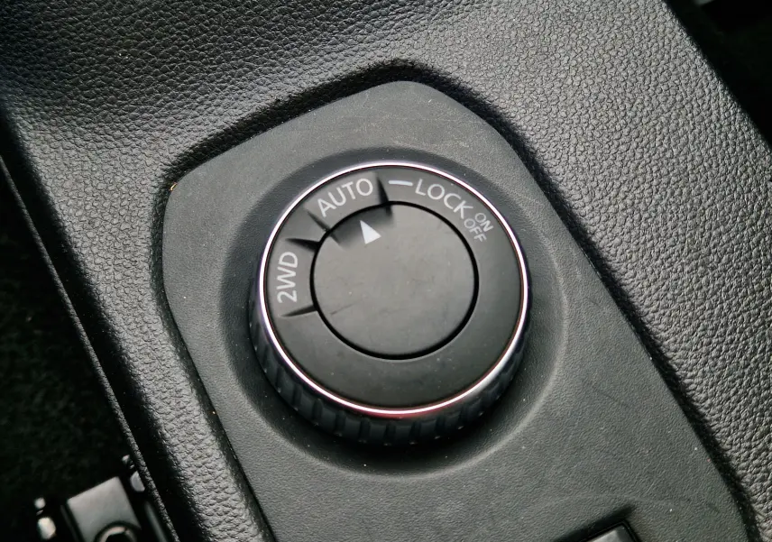 Gros plan sur le sélecteur de mode de conduite 2WD, Auto et Lock du Dacia Duster 4x4, intérieur noir texturé.