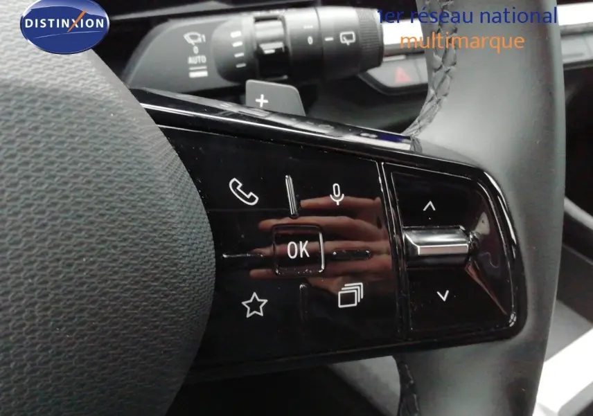 Gros plan sur les commandes multifonctions au volant du Renault Austral gris schiste, avec boutons tactiles et molette.