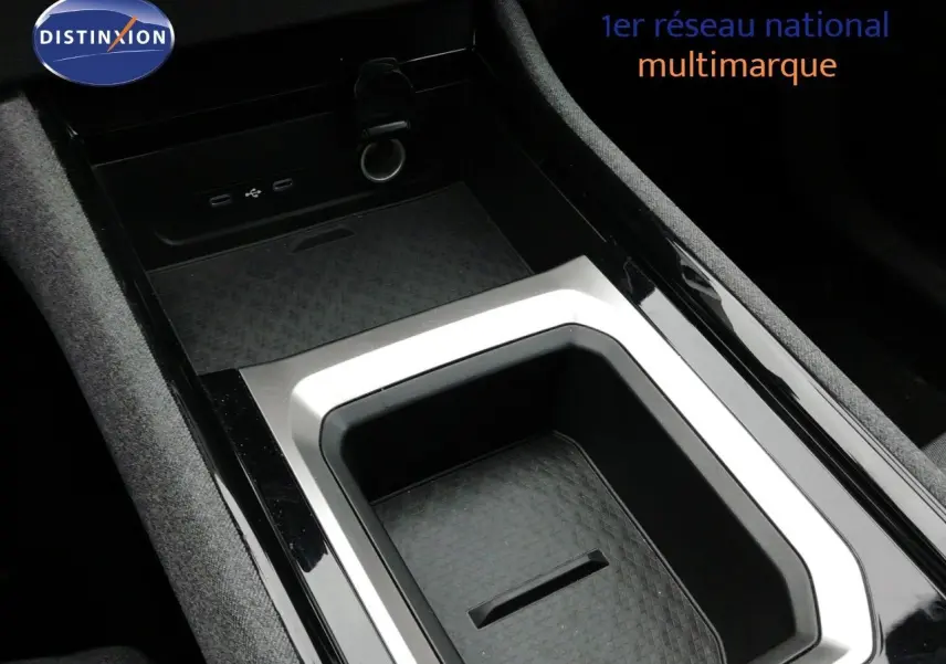 Gros plan sur la console centrale noire et grise du Renault Austral E-Tech Full Hybrid 2025 avec ports USB visibles.