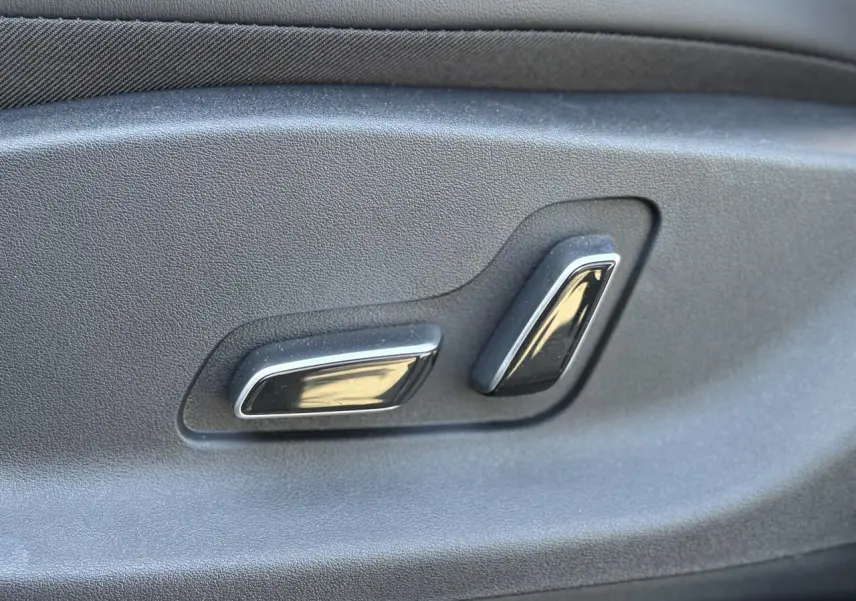 Gros plan sur les commandes électriques des sièges noirs à l'intérieur du BYD SEAL U 2025 couleur Boundless Cloud.